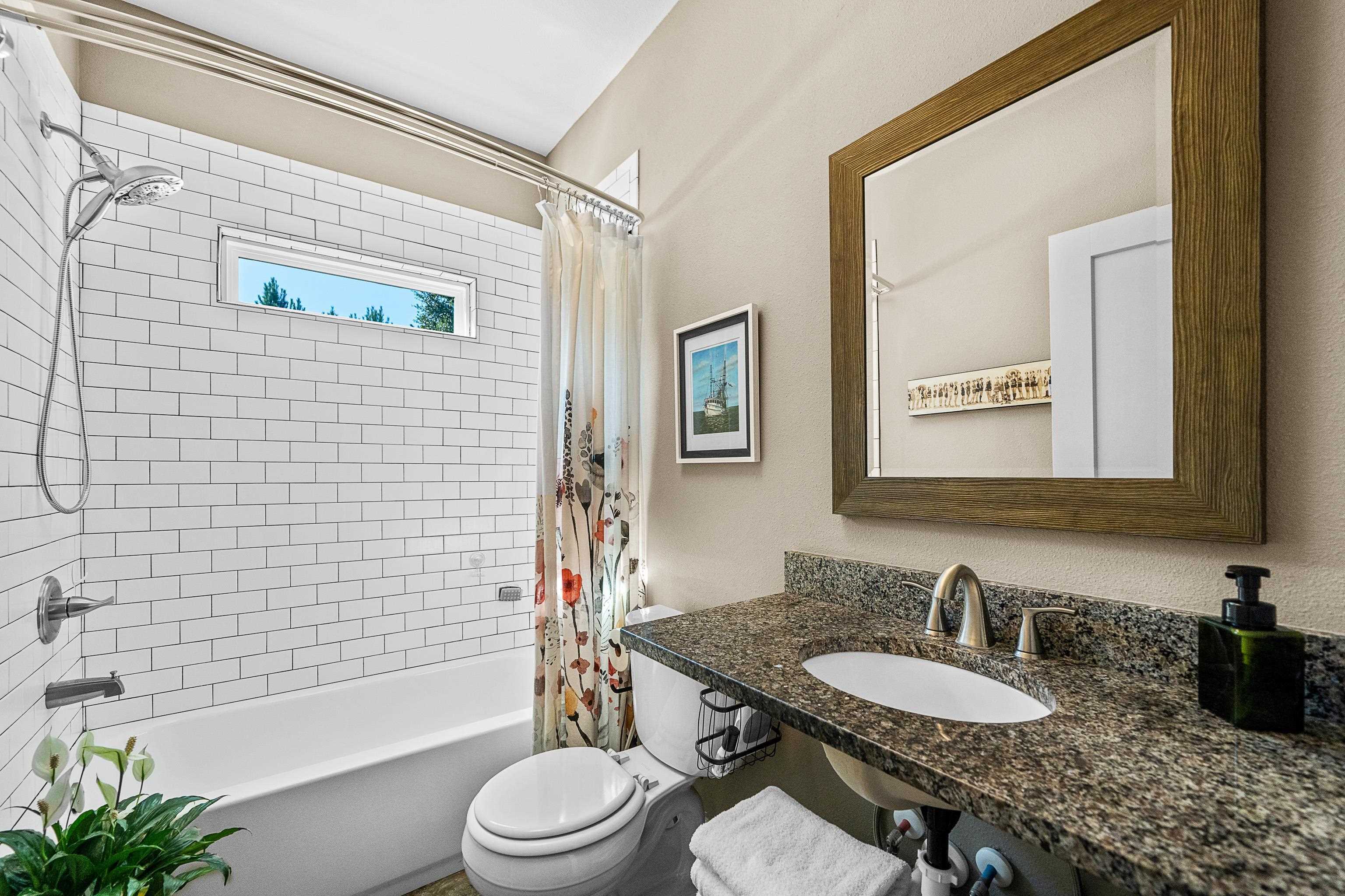 24616 Bretz Lane Elberta, AL 36530 - Photo 29 of 42 Full bathroom with custom vanity and tile surround tub/shower combo.