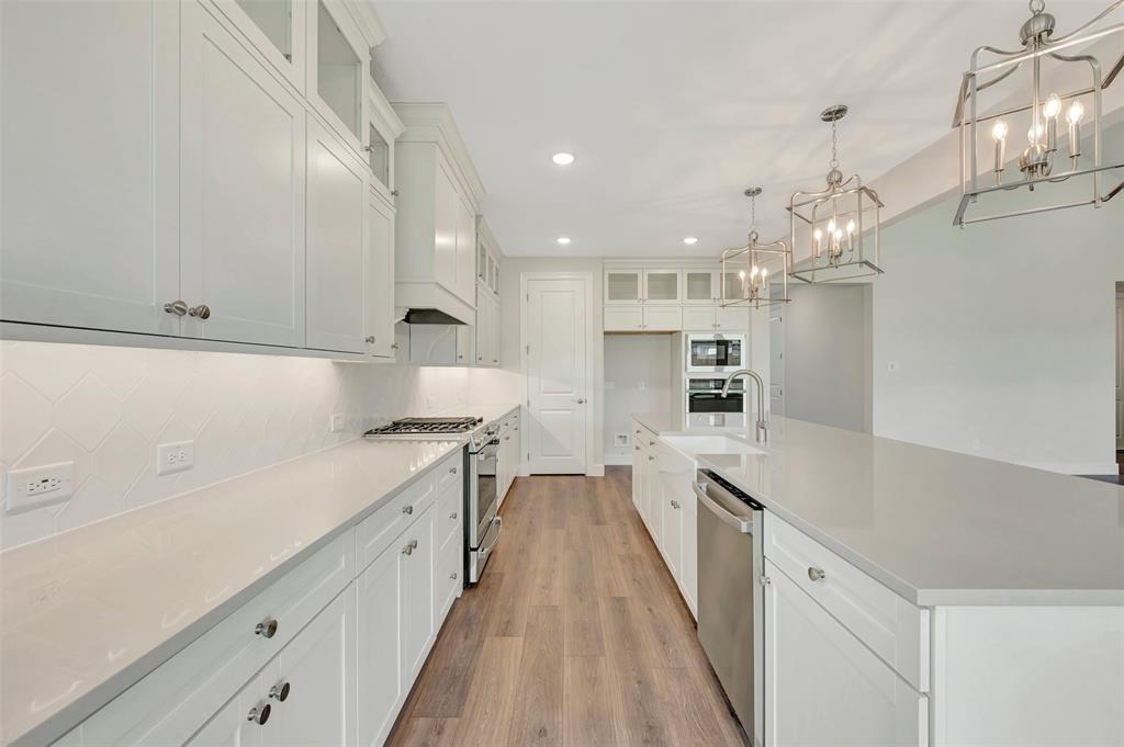 11460 Wulstone Road Fort Worth, TX 76052 - Photo 10 of 40 a large kitchen with cabinets and a stove