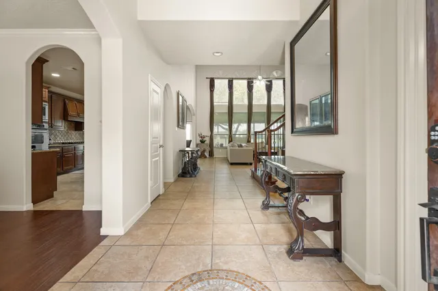 a view of a hallway with wooden floor and glass door