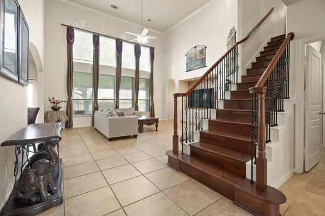 a living room with couches and a dining table next to a large window