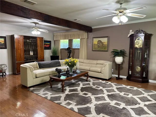 a living room with furniture a chandelier and a rug