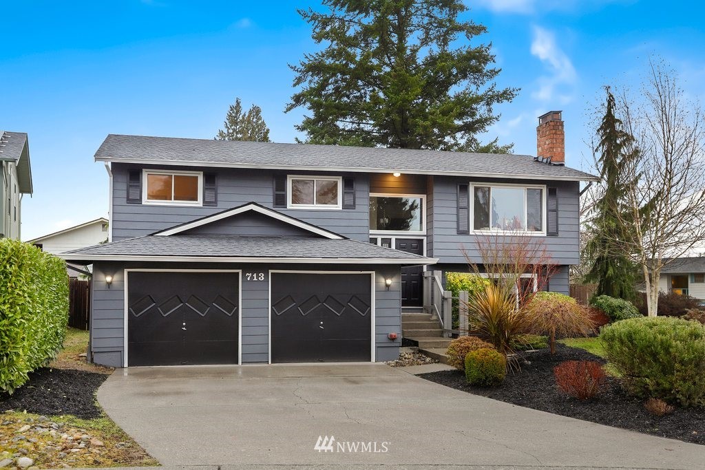 713 90th Place Southeast Everett, WA 98208 - Photo 1 of 32 a front view of a house with garage