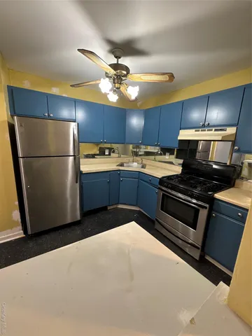 a kitchen with granite countertop stainless steel appliances and wooden cabinets