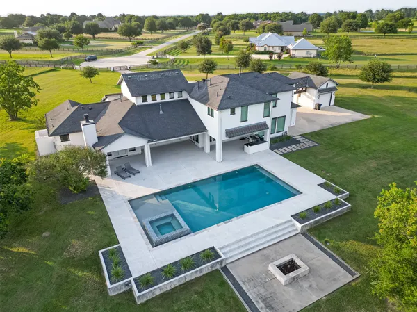 an aerial view of a house with outdoor space and lake view