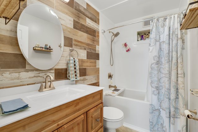 2005 South Finley Road, Unit 703 Lombard, IL 60148 - Photo 17 of 30 a bathroom with a sink a toilet and shower