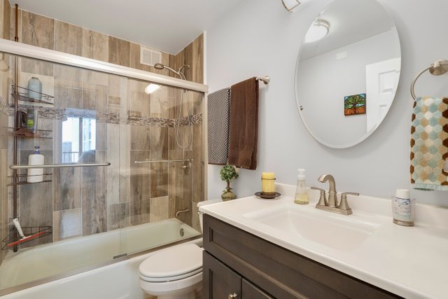 2005 South Finley Road, Unit 703 Lombard, IL 60148 - Photo 18 of 30 a bathroom with a sink a toilet and shower
