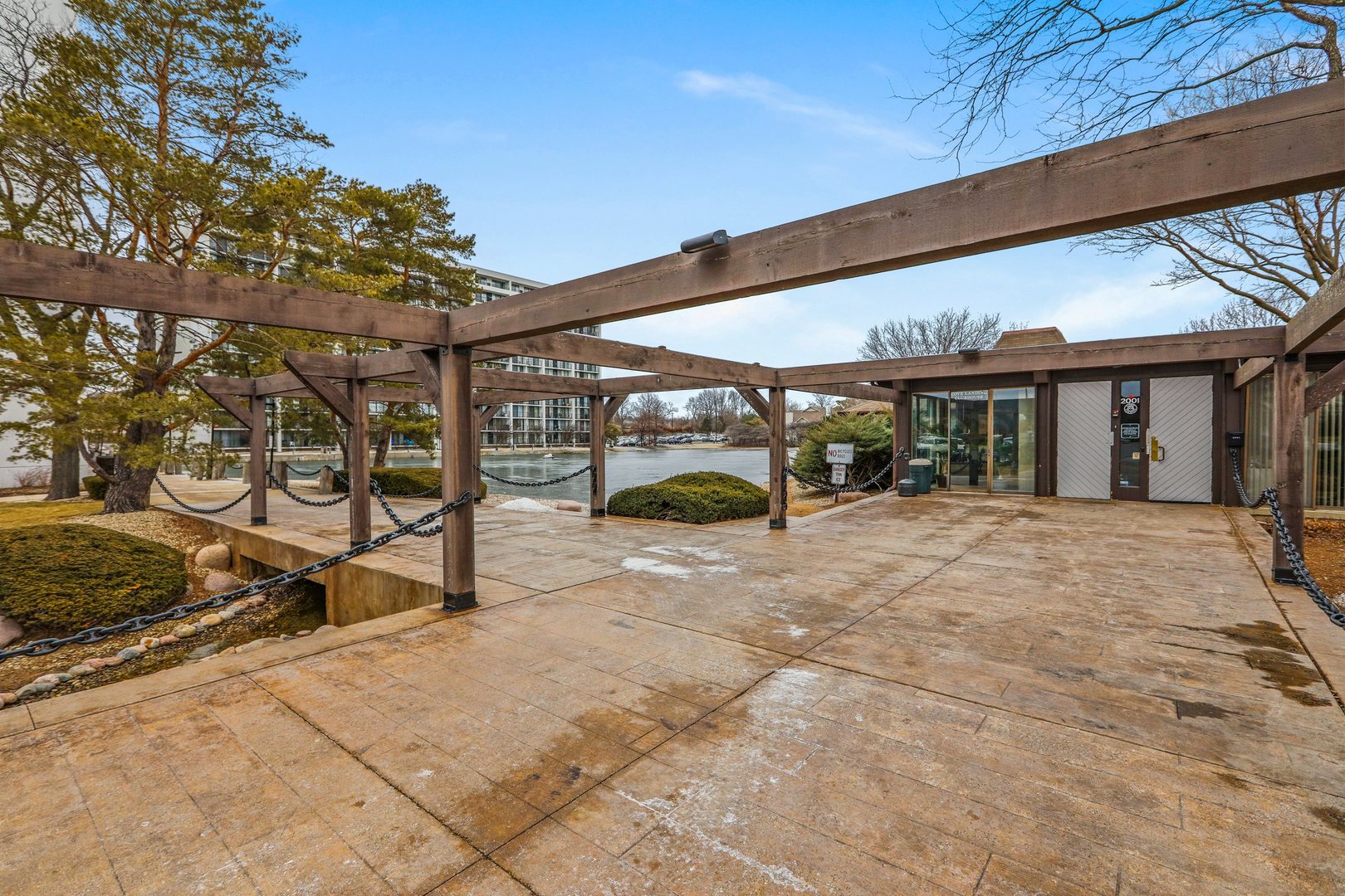 2005 South Finley Road, Unit 703 Lombard, IL 60148 - Photo 30 of 30 a view of a patio with table and chairs under an umbrella with a barbeque