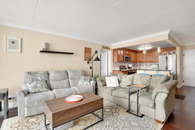 2005 South Finley Road, Unit 703 Lombard, IL 60148 - Photo 3 of 30 a living room with furniture and a view of kitchen