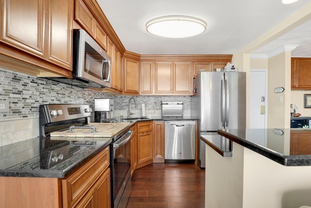 2005 South Finley Road, Unit 703 Lombard, IL 60148 - Photo 10 of 30 a kitchen with stainless steel appliances granite countertop a refrigerator a stove top oven a sink and dishwasher