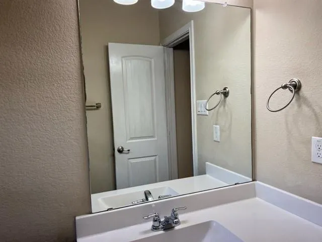 a bathroom with a sink and a mirror