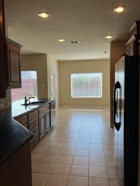 1716 Kachina Lodge Road Fort Worth, TX 76131 - Photo 5 of 21 a kitchen with stainless steel appliances a refrigerator and a stove top oven
