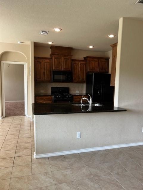 1716 Kachina Lodge Road Fort Worth, TX 76131 - Photo 6 of 21 a kitchen with a sink and a refrigerator