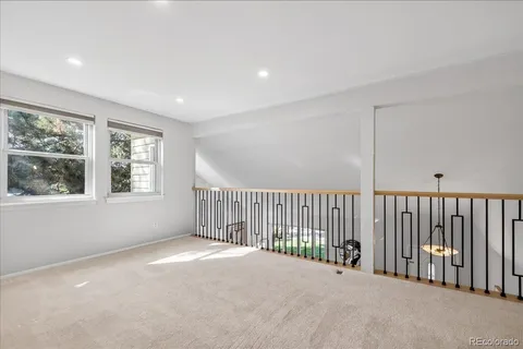 a view of a balcony with wooden floor and windows