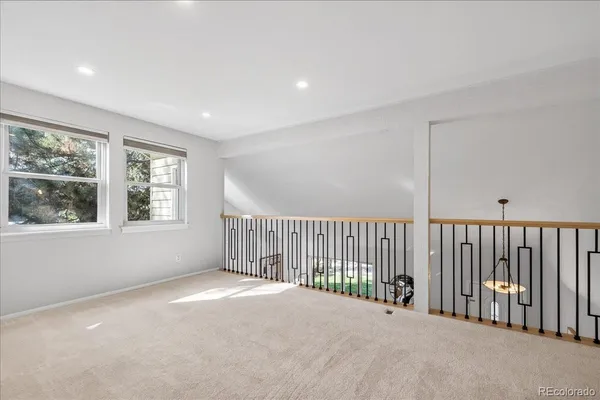 a view of a balcony with wooden floor and windows