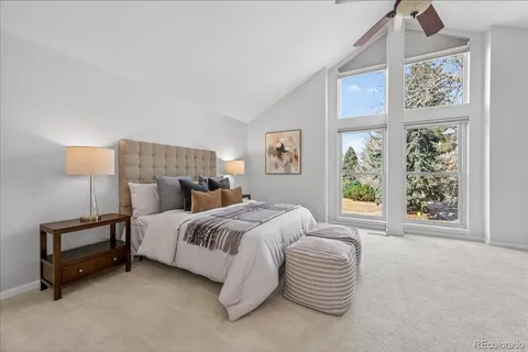 a spacious bedroom with a bed and a window