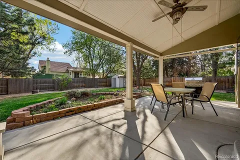 a view of a patio with a table and chairs