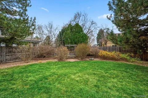 a view of a backyard with large trees