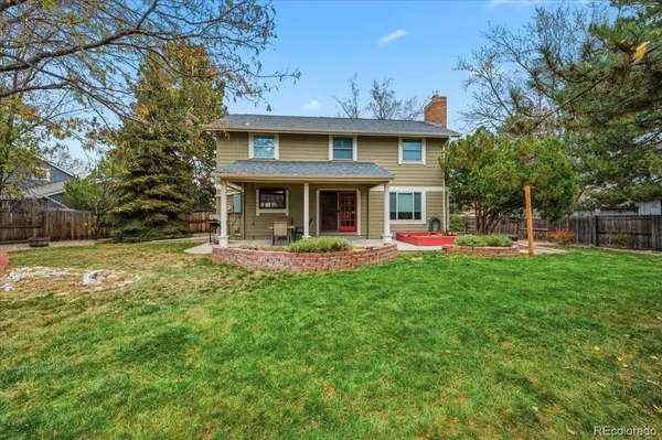 a view of a house with a backyard