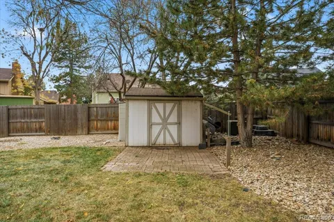 a backyard of a house with table and chairs