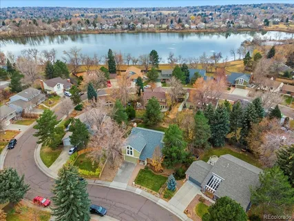 an aerial view of lake residential house with outdoor space and swimming pool