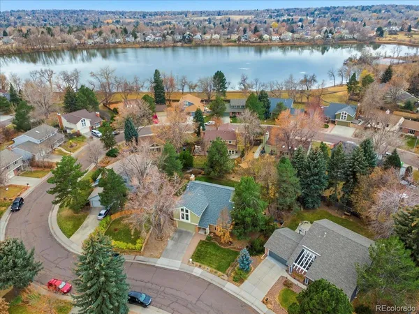 an aerial view of lake residential house with outdoor space and swimming pool