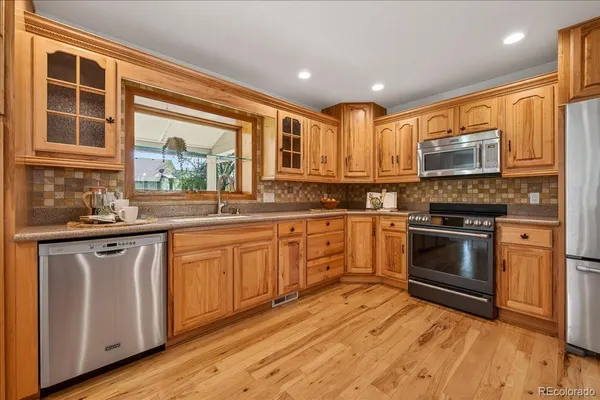 a kitchen with stainless steel appliances granite countertop a stove and cabinets