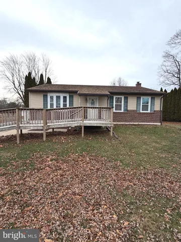 a view of a house with a yard and sitting area