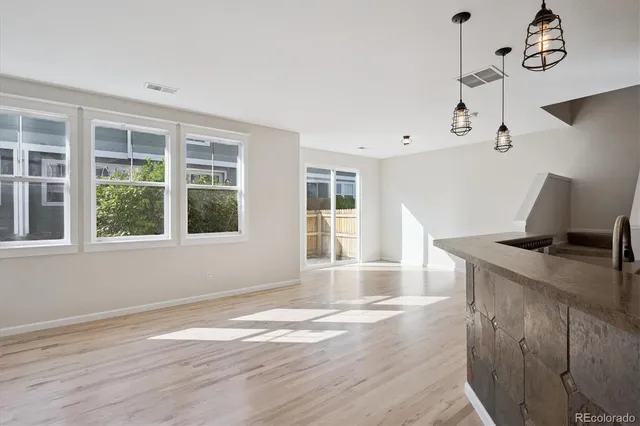a view of wooden floor and windows in a room