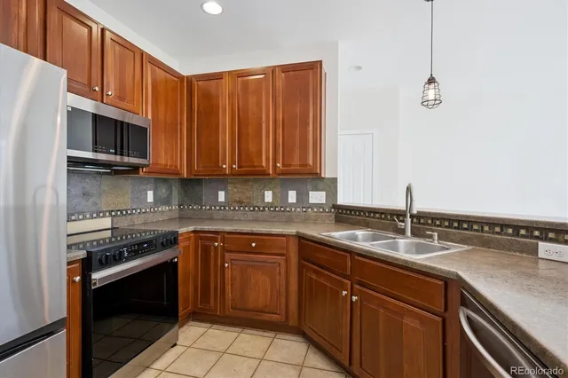 a kitchen with stainless steel appliances granite countertop a sink stove and microwave