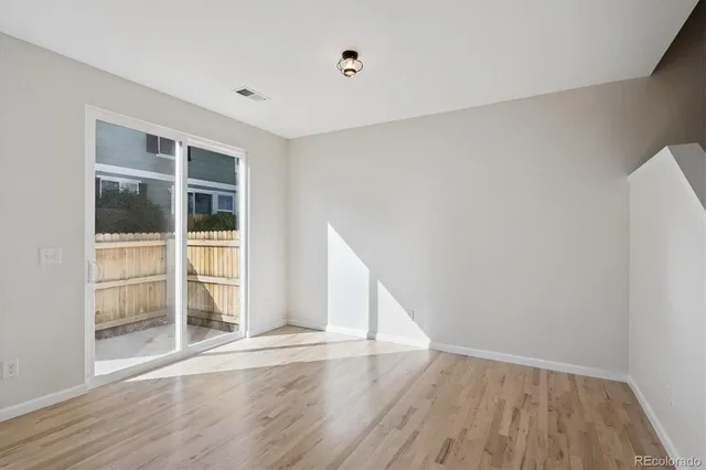a view of wooden floor and windows in a room