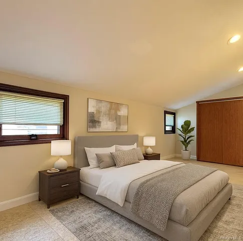 a bedroom with a bed and a couch