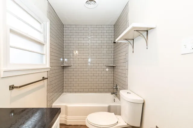 a bathroom with a toilet and a bathtub
