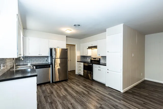 a kitchen with a refrigerator stove and sink