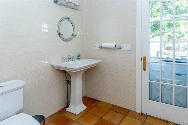 a bathroom with a sink toilet and a window