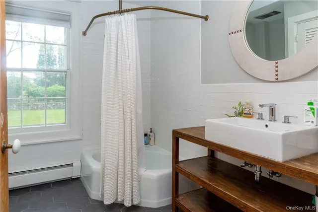 a bathroom with a sink a mirror and a window