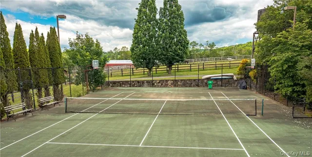 a view of a tennis court with chairs