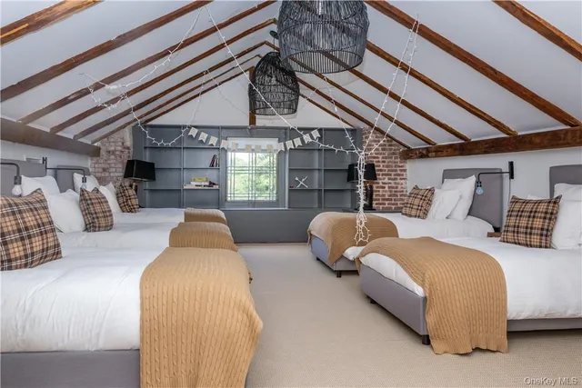 a bedroom with furniture and a large window