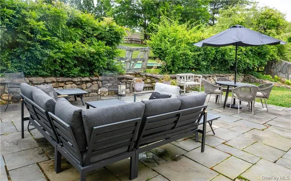 a terrace with outdoor seating and trees
