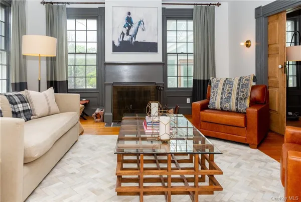 a living room with furniture fireplace and window