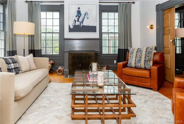 a living room with furniture fireplace and window