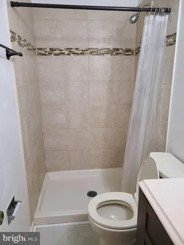 a bathroom with a toilet and a shower