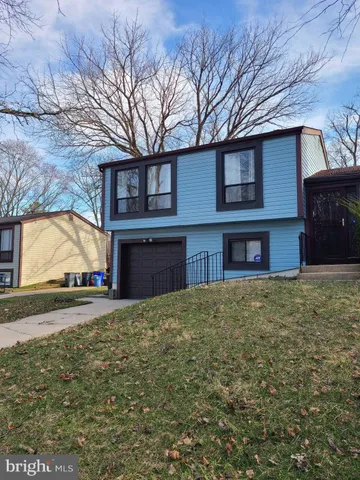a view of a house with a yard and garage