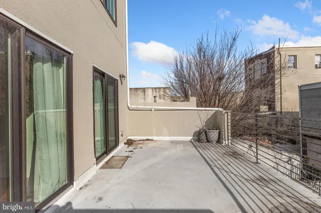 a view of backyard with tub and trees in the background