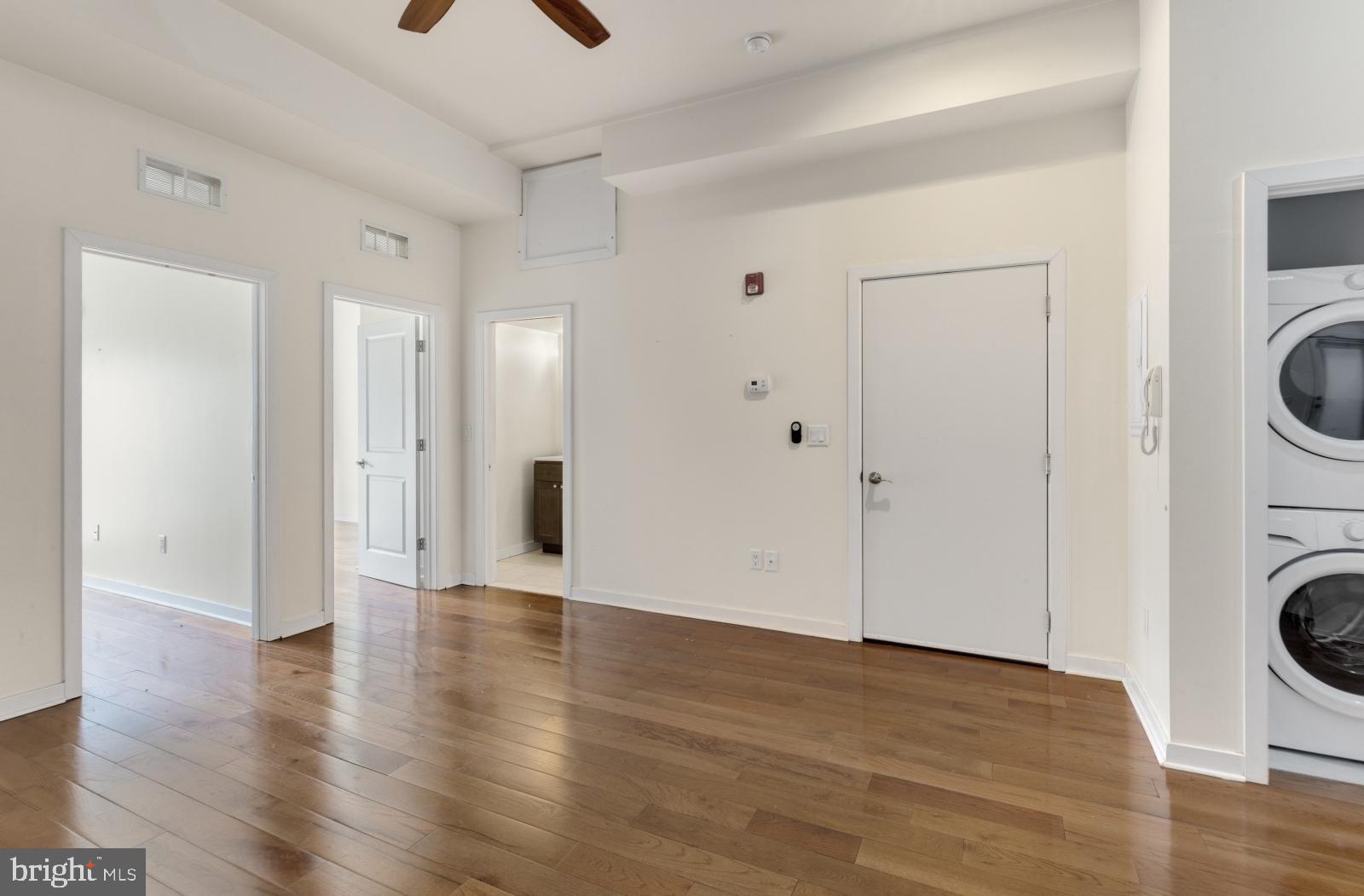 2031 South Juniper Street, Unit 204 Philadelphia, PA 19148 - Photo 3 of 31 a view of a hallway with wooden floor and a sink