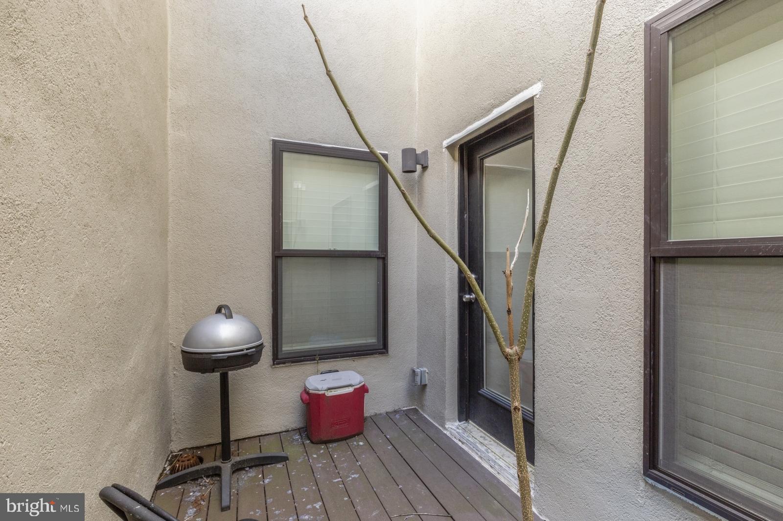 2031 South Juniper Street, Unit 204 Philadelphia, PA 19148 - Photo 10 of 31 a view of a hallway with wooden floor and staircase