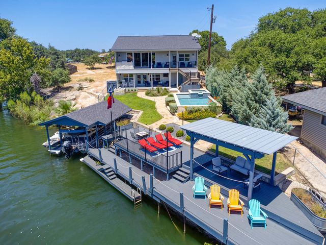 an aerial view of a house with swimming pool outdoor seating