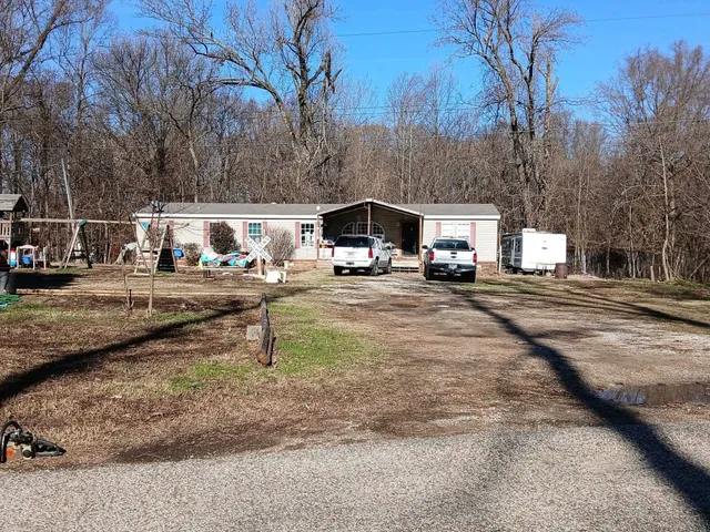 a view of road with card and trees