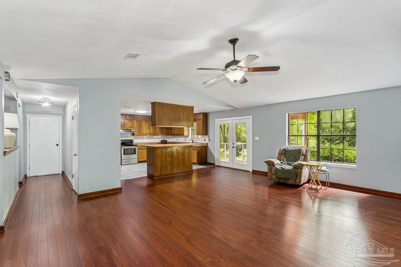 111 Cotton Creek Road McDavid, FL 32568 - Photo 11 of 37 a view of a livingroom with furniture hardwood floor and a ceiling fan