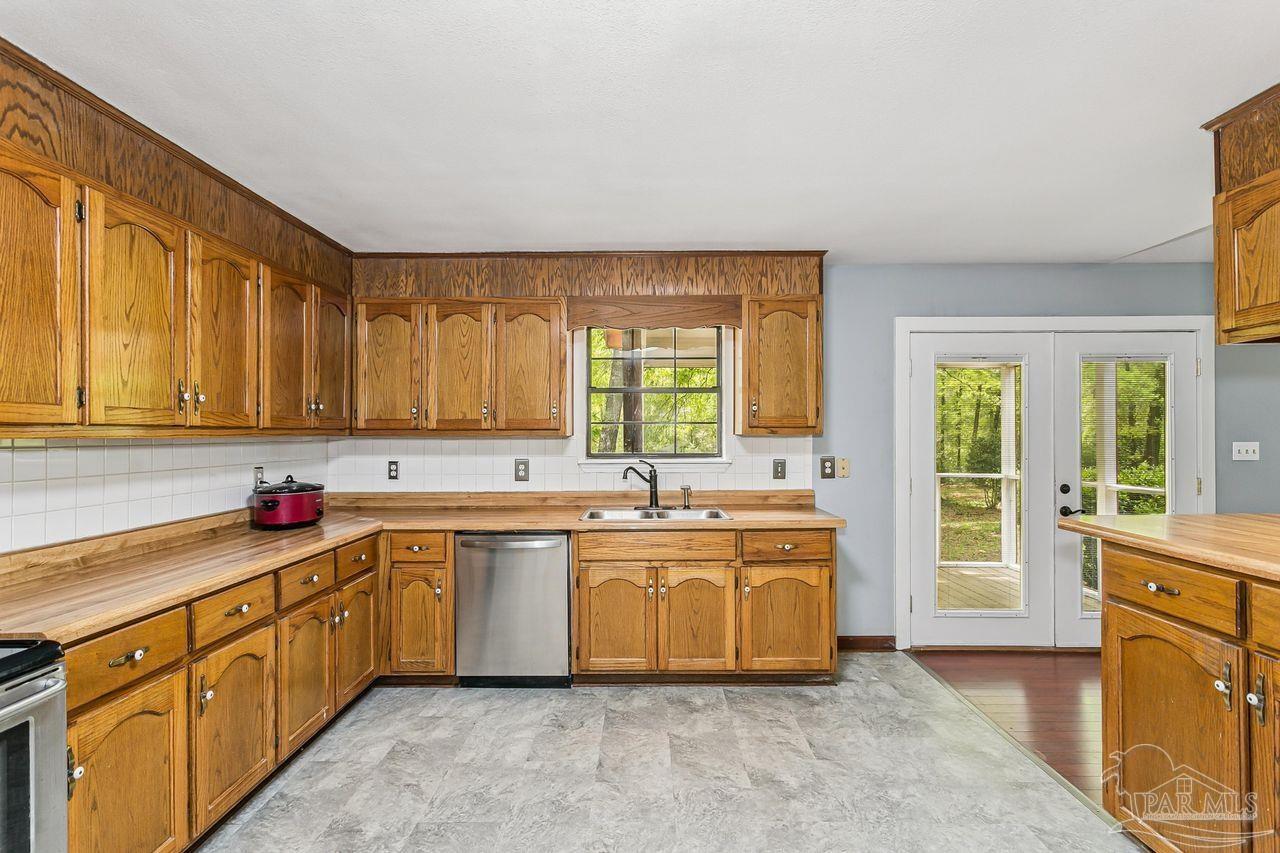 111 Cotton Creek Road McDavid, FL 32568 - Photo 15 of 37 a large kitchen with a sink and cabinets