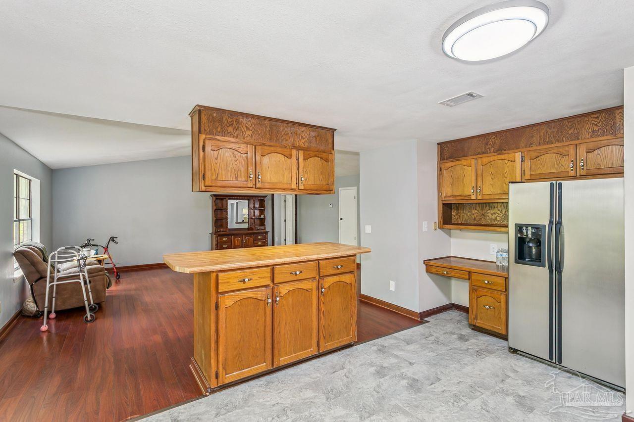 111 Cotton Creek Road McDavid, FL 32568 - Photo 16 of 37 a kitchen with stainless steel appliances granite countertop a refrigerator and microwave